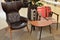 Interior of the room, a wood chair with red upholstery, a brown coffee table with device 220 Volt, 5 volt USB socket