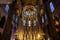 Interior of Santa Maria del Mar Basilica in typical Catalan Gothic style with pointed arches, high columns and colourful windows.