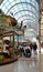 Interior of shopping mall `Val dâ€™ Europe` transparent roof - many shops, cafes and restaurants, Paris