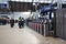 Interior shot of Queen Street Glasgow Railway Station during renovations.  Shows ticket barriers, signage and people