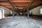 Interior of stable in horse breeding. Clean hay lying down on the floor. Drinker and stalls for horses in the background. Wide