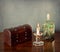 Interior still life: wooden chest,candle,glass bottle