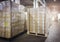 Interior of Storage Warehouse. Stacked of Package Boxes Wrapped Plastic Flim on pallet rack.