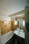 Interior of tiny hotel bathroom with clean bathtub,