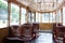 Interior of an tourism old vintage tram. Inside is empty, wooden red brown seats. Through the glass windows you can see the trees.