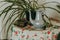 Interior of traditional house-museum from inside. Antique teapot and cups, kitchen utensil on flower linen tablecloth in Ethno mus