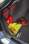 Interior of the trunk of the car in which there is a first aid kit, fire extinguisher, warning triangle, reflective vest, star