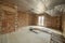 Interior of unfinished brick house with concrete floor and bare walls ready for plastering under construction. Real estate