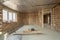 Interior of unfinished brick house with concrete floor and bare walls ready for plastering under construction. Real estate