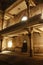 An interior view of an abandoned Hebrew Jewish synagogue bathed in rays of light.