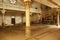 An interior view of an abandoned Hebrew Jewish synagogue bathed in rays of light.