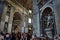 Interior view of the Basilica of Saint Peter in the Vatican with sculptures and crowd of tourists