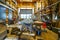 Interior view of a carpentry workshop with many tools an old wooden boat and its unfinished replica