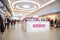 Interior view of modern shopping centre mall with customers walking about