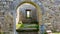 Interior view of the ruins of the medieval Killilagh church through a stone gate in the village of Doolin