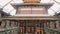 Interior view of Sri Dalada Maligawa, showcasing intricate temple designs, murals, Buddhist flags. Visitors explore