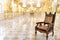 Interior view of vintage wooden chair in luxury mirror room or hall decorated with chandelier