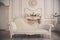 Interior with vintage furniture, light spring studio with beautiful white sofa and flowers in vases. White interior of