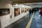 Interior and walkway of Osaka subway with row of art picture on the wall