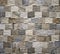 Interior wall covering made of little squares porcelain stoneware with wood effect .