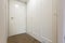 Interior of a white hotel corridor with closet