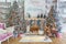 Interior of white lving room with big windows and Christmas New year decor,light garland and Christmas tree with presents under it
