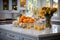 The interior of a white spacious kitchen decorated with yellow ripe pumpkins and flowers. Generated by AI