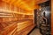 Interior of wooden finnish sauna with birch broom, bucket and stove. The Finnish sauna is a substantial part of their