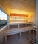 Interior of wooden finnish sauna with window. Luxury private house.