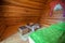 Interior of a wooden hut providing a dining set and a bed at a glamping site at Lake Bloke