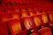 Interiors empty reddish cinema chairs seats in low-key indoors