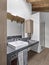 Interiors of a modern bathroom in the attic room with wooden  beamed ceiling and the wooden floor