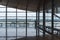 International airport interior corridor with seats and glass frame and reflections window in airport terminal departure hall