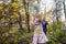 International bride and groom together in green city park