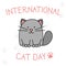 International Cat day vector postcard. Cartoon grey cat and handwritten text on white with paws prints