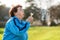 International Day of Older Persons. Portrait of an elderly caucasian grandmother blowing on a dandelion. Park in the