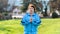 International Day of Older Persons. Portrait of an elderly woman in sportswear doing yoga in a park. Grass in the