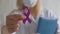 International Epilepsy Day. Doctor in coat holds purple ribbon on white background. Alzheimer's disease