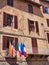 International Flags Flying From Apartment Building Balcony, Siena, Italy