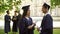 International graduates with diplomas having conversation, student exchange