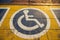 International handicapped symbol painted on walking path in the park background