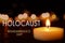 International Holocaust Remembrance Day. Burning candle on black table, closeup