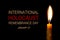 International Holocaust Remembrance Day January 27. Burning candle on black background