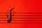 International Jazz Day. Silhouette of a big and amall notes cutted out of felt, on a red background in the form of a