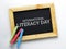 International Literacy Day. Wooden Frame Blackboard with Colorful Chalk