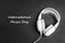 International Music Day background with white headphones on black backgrounds.