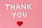 International`s nurses day, week concept, Text Thank you by tablets and red heart on pink background.