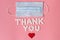 International`s nurses day, week concept, Text Thank you by tablets and red heart on pink background.