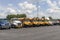 International Semi Tractor Trailer trucks and buses lined up for sale. International is owned by Navistar