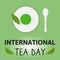 International Tea Day Celebration World on 15th december. Postcard Cup of matcha tea, spoon, saucer plate and tea leaves on green